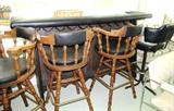 Vintage Bar Set...includes large bar with black Naugahyde upholstered top rail and front,  5  rotating bar stools with spindle backs and legs,  black Naugahyde upholstered seats and back rest inserts (Other bar stools are shown elsewhere in this collection).  Also shown is 1 of  4 bar stools with metal bases and black Naugahyde upholstered seats and backs. (Other matching bar stools are shown elsewhere in this collection.