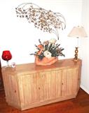 Mid Century Modern Credenza with blond finish (likely circa 1960's).  Credenza has door storage on both sides and the front.  Also shown is a nicely done unique copper metal sculpture  wall  artwork depicting wind blown branches and leaves...perhaps willow or bamboo...  Whatever they are they will go nicely with virtually any decor.  The accent table lamp and the swan floral arrangement are also available.