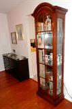 Elegant Federal Style  Lighted Curio Cabinet by Drexel, with 5 Glass Shelves for Display, Mirrored back...glass and wood doors...  Nice rich looking mahogany finish. Curio Cabinet is matching to other Drexel furniture pictured elsewhere in this collection. Note: many of the figurines and accent items displayed in the Curio cabinet are also available and are separately pictured elsewhere in this collection. Also shown is a Vintage Dresser with 6 Drawers storage and dark finish; Also shown are some of the decorator plates...Bradford Exchange, others that are available in this sale. Artworks shown are also available.