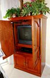 Nice Armoire with double doors storage and brass pulls...rich finish. Sony Color TV, Sharp Stereo Receiver, Accent Table  Lamp with brass base, and 
Silk Florals also shown are available.