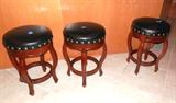 Set of Three Matching Swivel Bar Stools...nicely curved wooden legs, black leather upholstered seats with braded accents. Bar Stools are sized so they may be used  for counter seating for entertaining or dining.