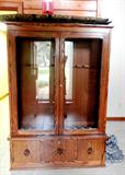 Oak Gun Cabinet with Glass & Wood Double Doors (with key lock), and drawers storage with brass ring pulls.  Gun Cabinet has spaces for  holding up to 10 rifle / shotguns.  Also shown are two soft rifle carrying cases.