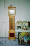 Early American Style Grandmother Clock by Ware. Clock has wood & glass cabinetry, pendulum and weights