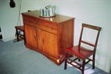 Mid Century Early American Server with single drawer and double door storage. Also pictured 2 matching mahogany finish side chairs.