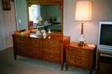 Vintage Hibriten Bedroom Set: As Pictured: Double Dresser with brass pulls and with Mirror; Matching Night Stand with Drawer Storage; Accent Lamp;
(Other matching pieces to this set are separately pictured)