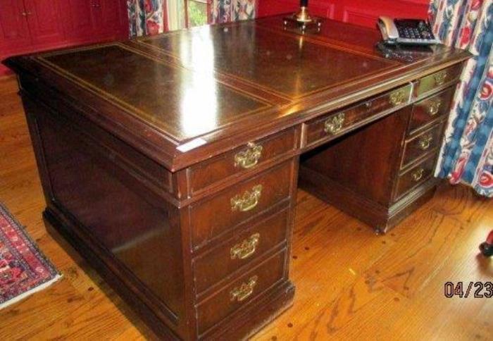 Partners Desk 
Leather top, has matching drawers/file drawers on both sides 
Has a few dings on one side from chair wheels hitting it. 
Dark cherry finish with dark olive green leather top, with gold edging. 
Measures: 
29"H x 59"W x 40"D