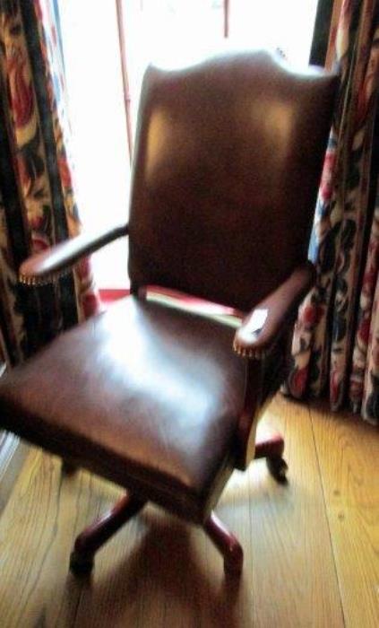 Leather executive swivel chair 
Oak wood base 
Brown leather seat and back has a few dings on back from bumping against a desk. 
42"H back