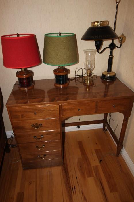 Small writing desk and nautical themed table lamps.