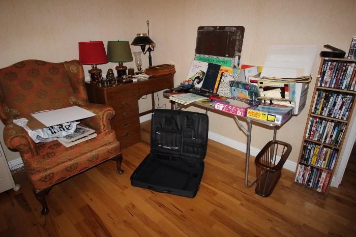 DVDs, desk, art portfolio case, fireside chair, mid century magazine rack, office supplies and photographic paper.
