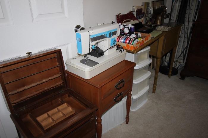 Sewing cabinets, electric sewing machine, storage bins.