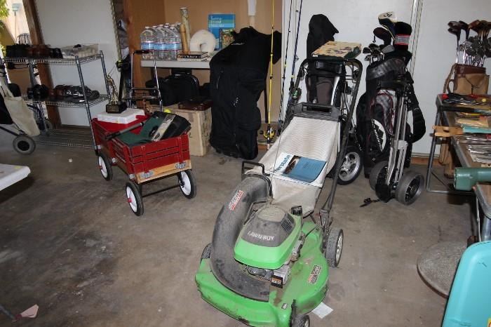 gas lawn mower, hedge trimmer, wagon, golf clubs, golf travel bag, metal storage shelves.