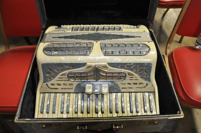 Antique Accordion with mother of pearl detailing.