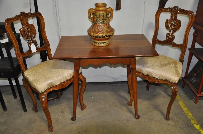 Stickley side table in cherry with antique French carved chairs.