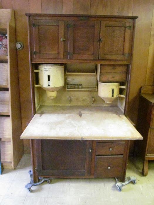Antique Hoosier Cabinet with Original Sugar, Flour and potato bins.  Original cutting board.  Original spice jars.   Original interior shelves.  Original maker's badge.
