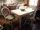 Kitchen table with white tile top and 4 chairs