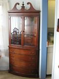 This vintage cherry corner cabinet is in excellent condition.