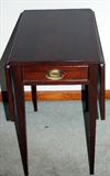 Vintage mahogany end tables with center drawer and dropleaf sides.