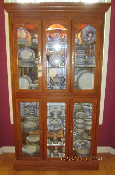 Lighted display cabinet filled with Russian fine china