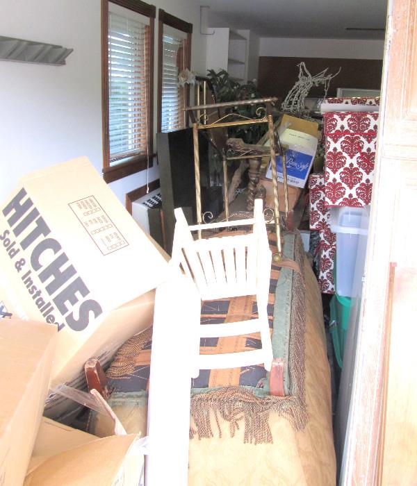 The unloading to load the house begins.  Two 2 car garages, not quite stacked to the rafters but close to the ceiling.