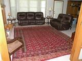 Beautiful authentic Persian rug. Leather sofa and Loveseat.