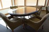 Round glass top table with four matching chairs. 