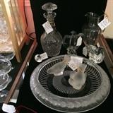 Foreground: Large Lalique Center Bowl signed "Margrite", pair of Lalique Sparrows,, background left to right: Zwarovski diamond Paperweight, Waterford Decanter signed "O'Leary" Baccarat Eagle, Pitcher by Baccarat, Steuben Eagle