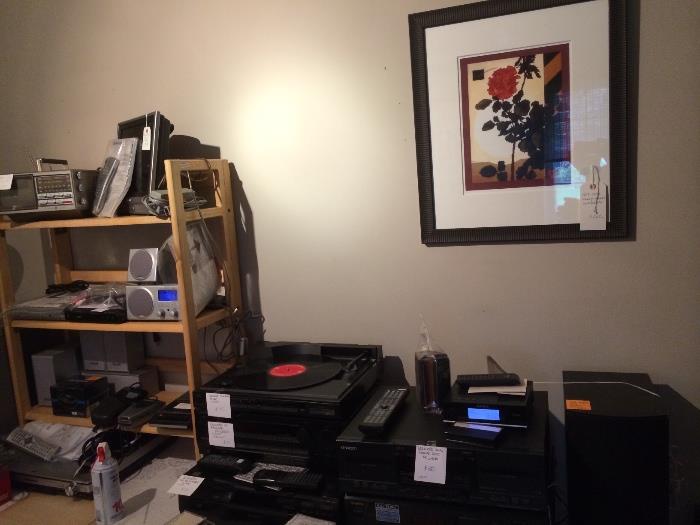 On the table: Linear tracking turntable, FM tuners, receivers, miscellaneous electronics all tested. On the wall: Guy Juke signed print also in the room: Peter max signed poster, Kinky Friedman for Gov poster, CD's LPs and cassettes.
