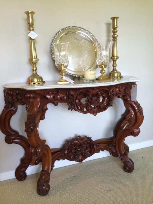 Beautifully carved rosewood Rococo console with Italian marble top. Atop console: pair of Waterford hurricanes signed O'Leary, Silver plate tray and brass candlesticks,