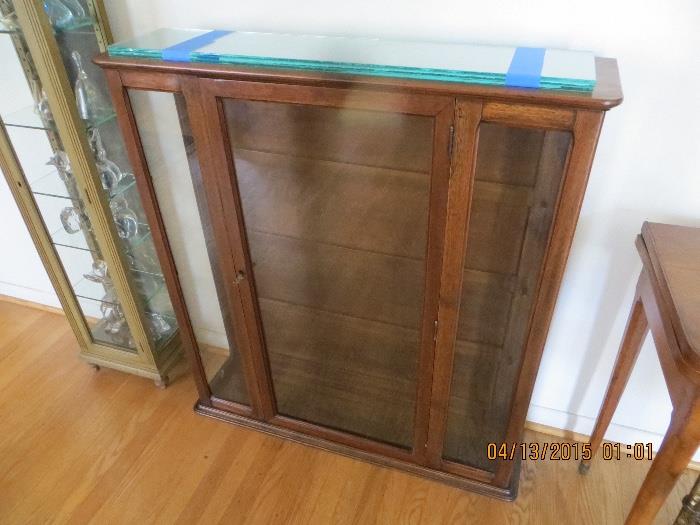 Walnut display cabinet with glass shelves