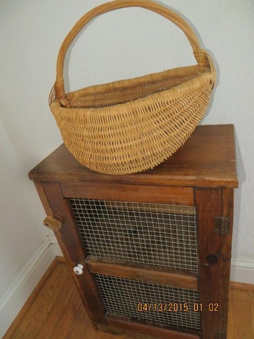 Handmade gathering basket sitting on  Handmade wire mess wooden door frame, pine