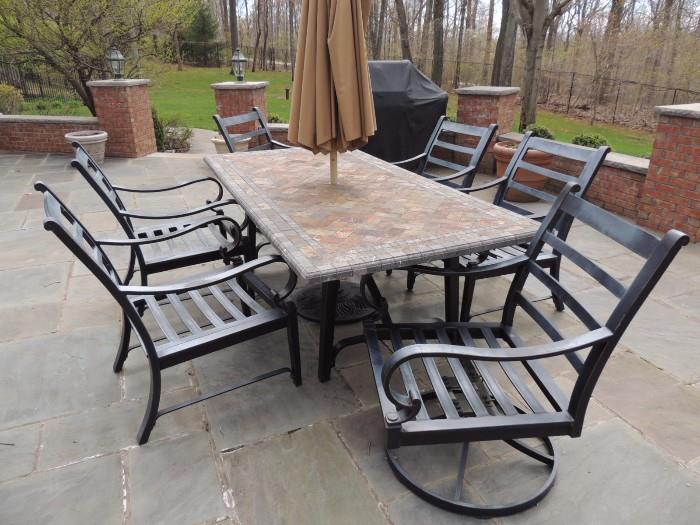 patio table with umbrella and 4 chairs and two arm chairs