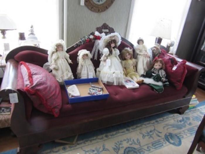 Empire couch with dolls on it. 