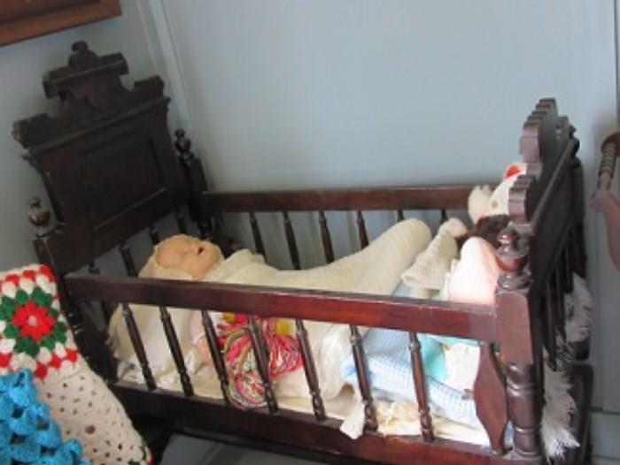 The baby cradle is walnut and is in excellent condition. 