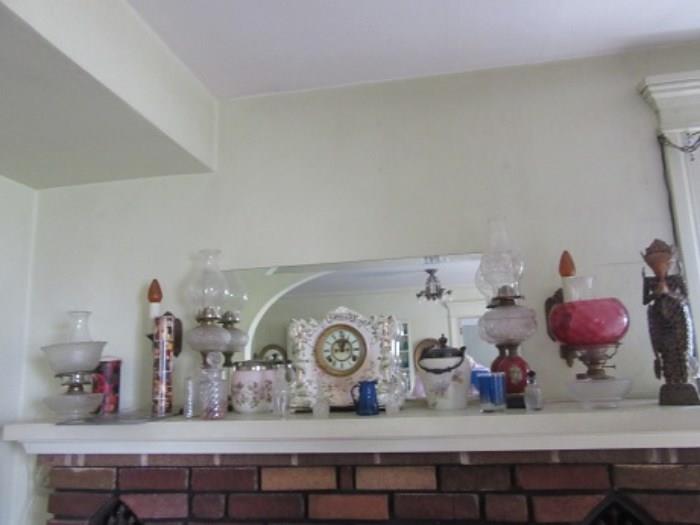The mantle in the living room has a Ansonia ceramic clock, two cracker jars, oil lamps and a unique oriental lady made out of coins.  