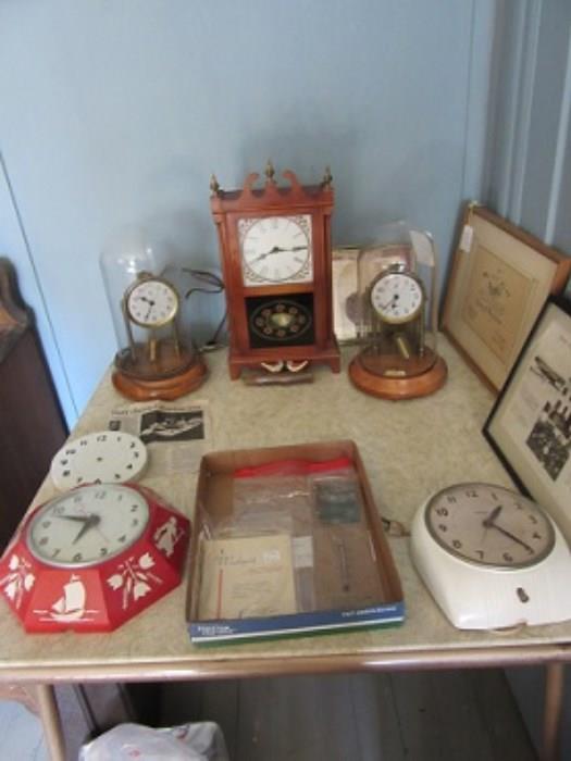 Barr Manufacture made clocks in the 1930-50's in Weedsport. This table shows clocks and clock parts made in Weedsport.  The paper in for forefront is local paper from Weedsport businesses. The framed pieces are 1932 and 1940 SU.  