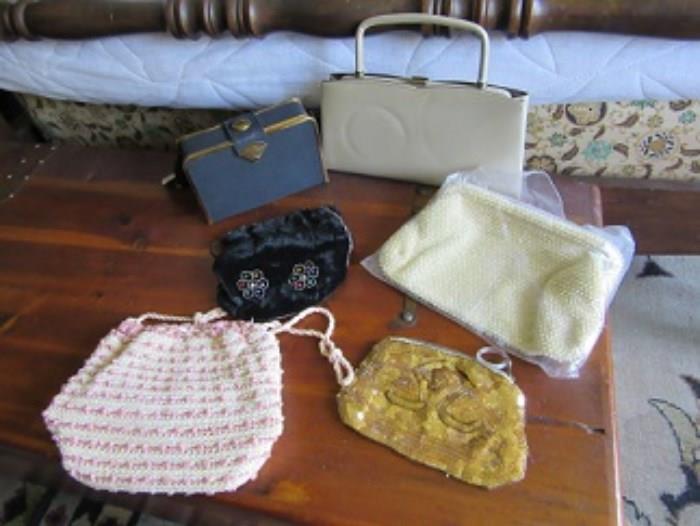 Sample of the handbags. the top left is a pill box purse, the black velvet below it is a 19th C bags with hand sewn beads, the white one next to the black is a pearl bag from the 1940's. Below that is a gold sequin bag.  More purses and bags will be in the sale. 