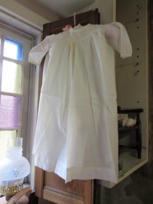One of  4 baby dresses or gowns.  There are youth dresses with smocking,  All in good condition.