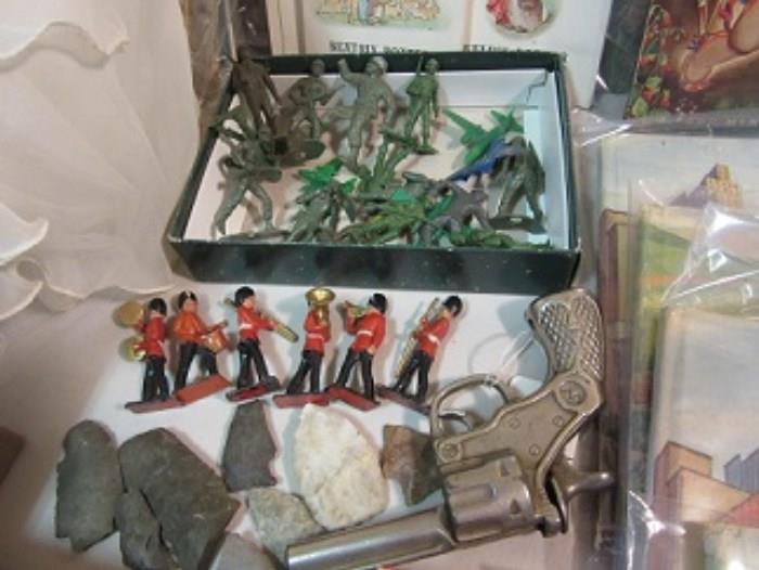 Top has WWII plastic or rubber army guys.  The red jacket soldiers are English and each has an instrument, the arrowheads , and a child's gun