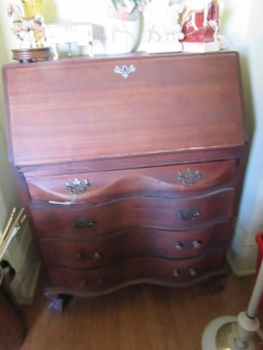One of the 3 desks in this sale.  It has drawer storage underneath a fitted interior desk.  