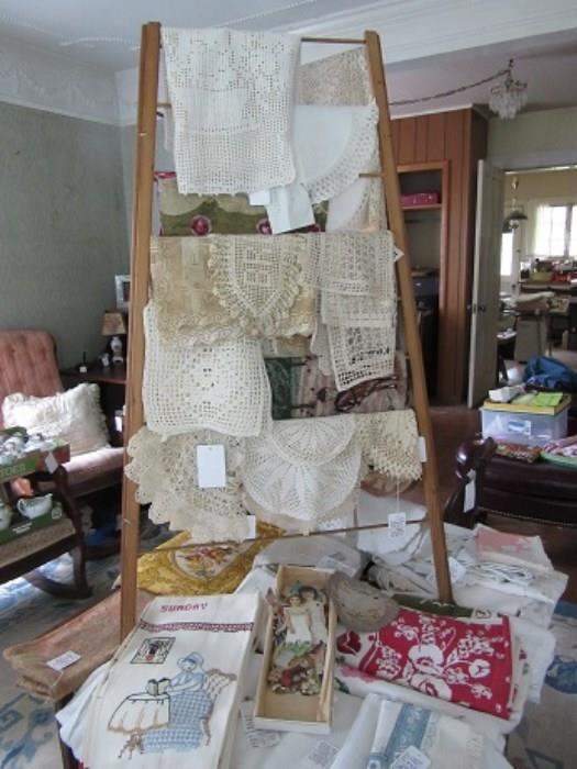 This photo shows some of the hand made lace.  The colorful table cloths are also shown.  Irish Linen, hand made lace and tapestries are all in the sale. 