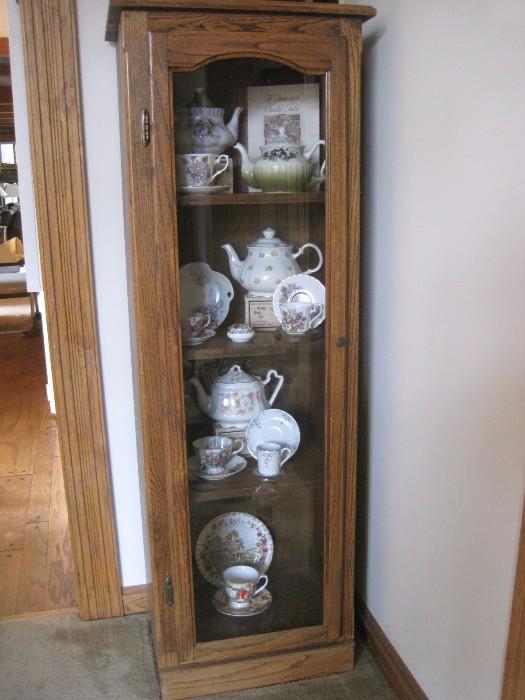 CURIO CABINET FILLED WITH ENGLISH BONE CHINA TEAPOTS AND TEACUPS