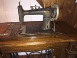 From the 1800s, Working Chautauqua Sewing Machine with original Leather Belt. Very Rare and a Beautiful Piece of furniture as well.