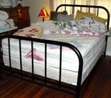 This is a very good iron bed on rollers. Nice mattress and springs.
