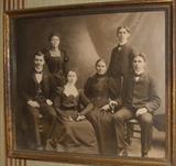 Many old framed photographs.