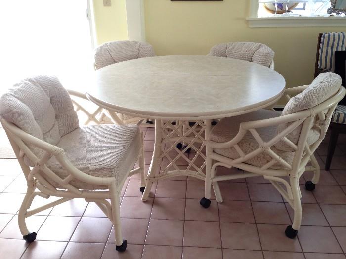 Bamboo Kitchen Table with leaf and four armchairs on casters. 