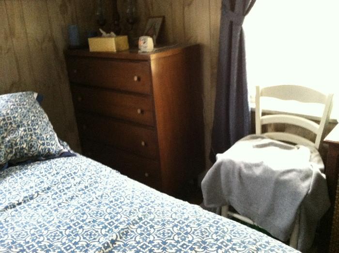 Four-drawer dresser and small chair.
