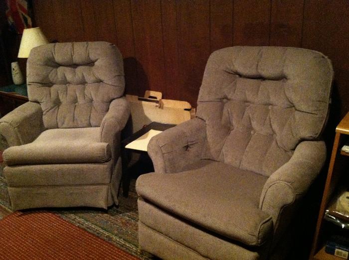 Two of three neutral-colored armchairs.