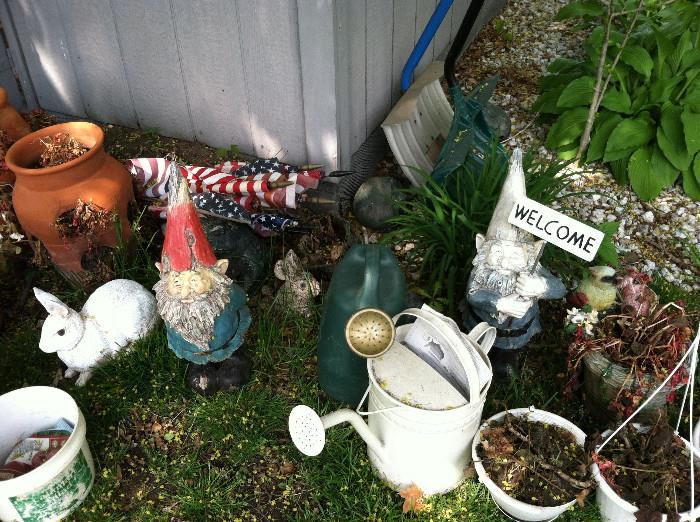 Garden gnomes and other outdoor decor. The shed contains a few garden tools.