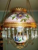 Closer view of hand painted oil lamp with hand painted Victorian Shade and base converted to electricity.