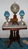 1880s Victorian marble top walnut parlor table with three lamps; one with an added hand painted Victorian shade